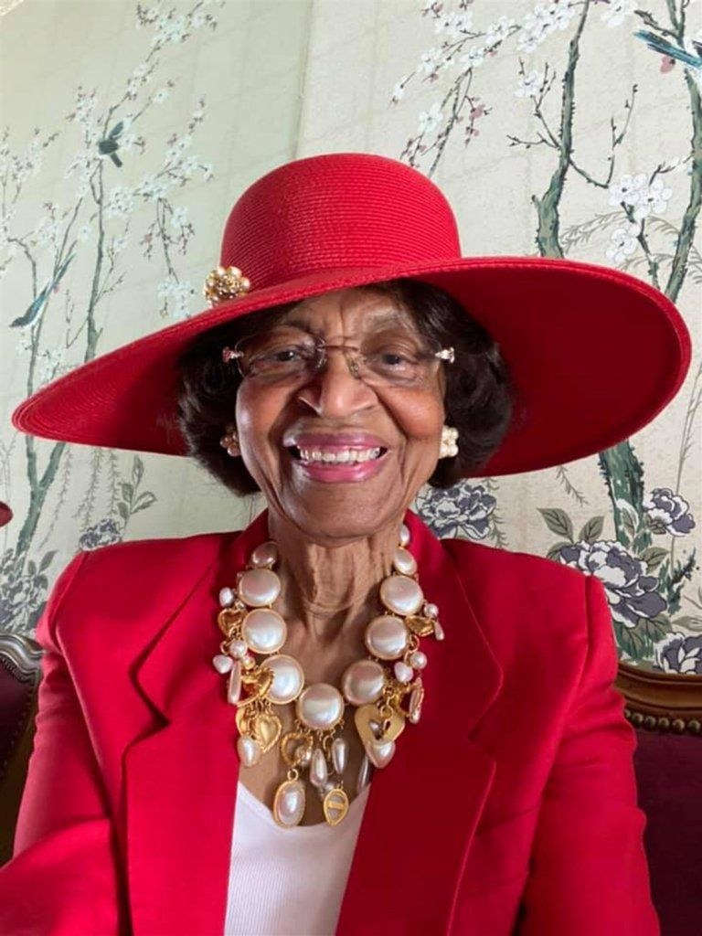Woman over 70 with red Statement Hat, Hair Kept Simple — church and Sunday hairstyle for women over 70