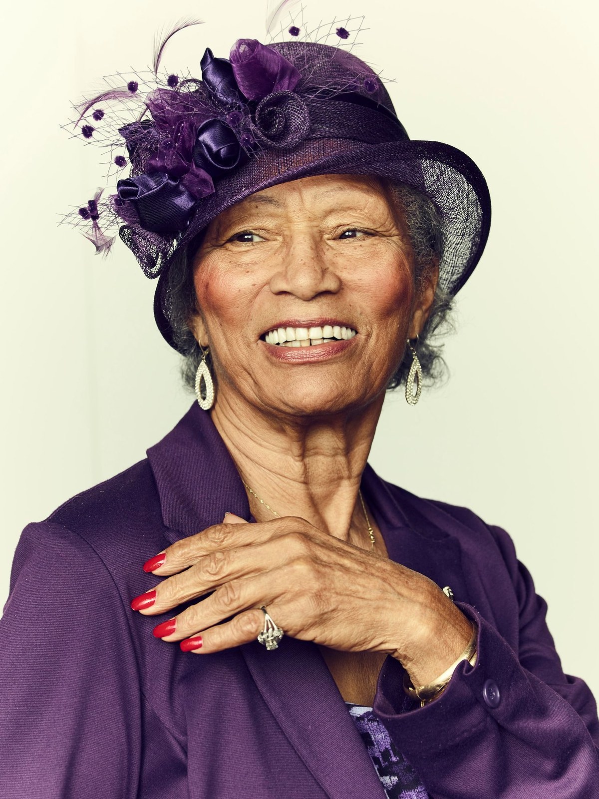 Woman over 70 with purple Hat with a Neat Short Style — church and Sunday hairstyle for women over 70