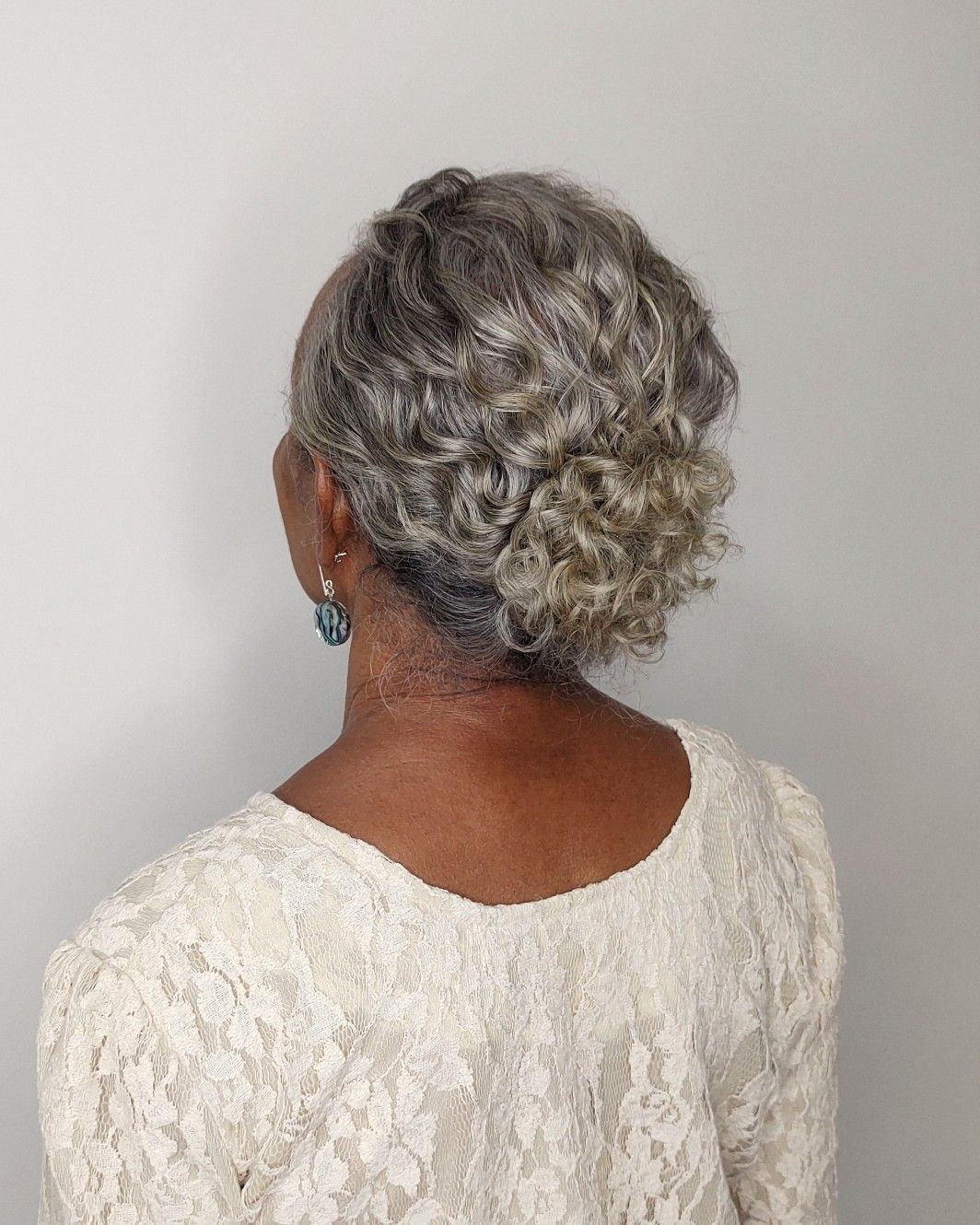 Woman over 70 with soft Rolled Pin-Up — easy short-hair updo inspiration for women over 70