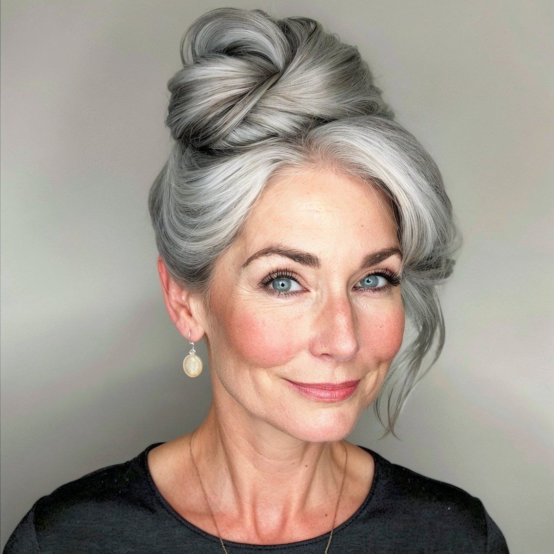 Woman over 70 with soft Updo With Face-Framing Tendrils — elegant wedding hairstyle for grandmothers over 70 inspiration for women over 70