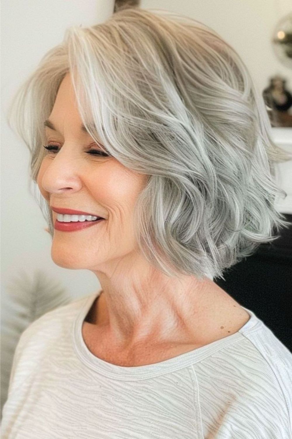 Woman over 70 with a wavy layered bob with a gentle smile — face-lifting haircut with soft layers for women over 70