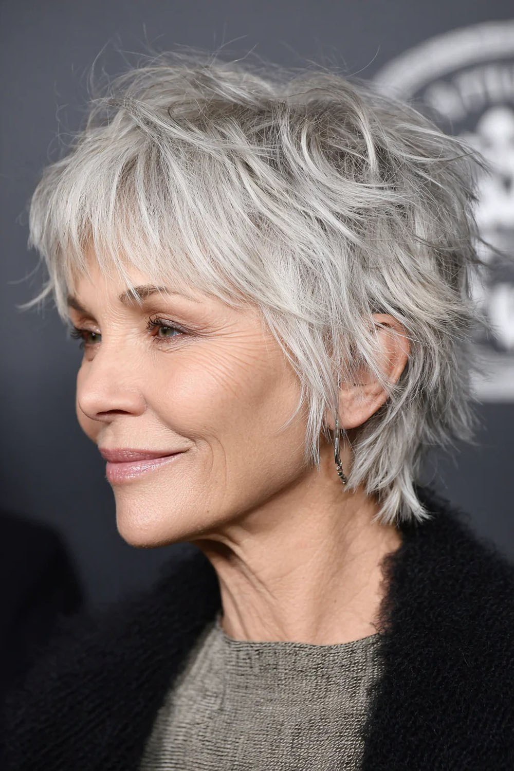 Woman over 70 with a shaggy layers with a feathered fringe — face-lifting haircut with soft layers for women over 70