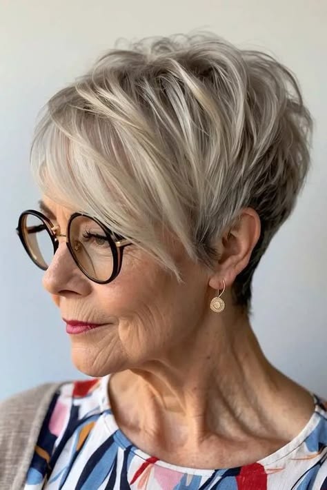 profile of a woman over 70 with an ash-gray pixie bob wearing round glasses