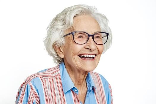 laughing woman over 70 with joyful white wavy hair wearing navy glasses