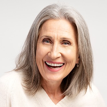 Gray shoulder length haircut on a woman over 70 with silver hair - Steel Gray Shoulder Cut With Feathered Layers