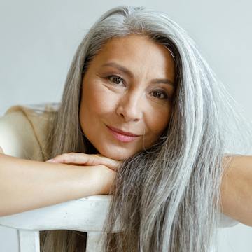 Going Gray: Long Silver Hair, Proud and Free — woman over 70 comparing going gray versus keeping hair color