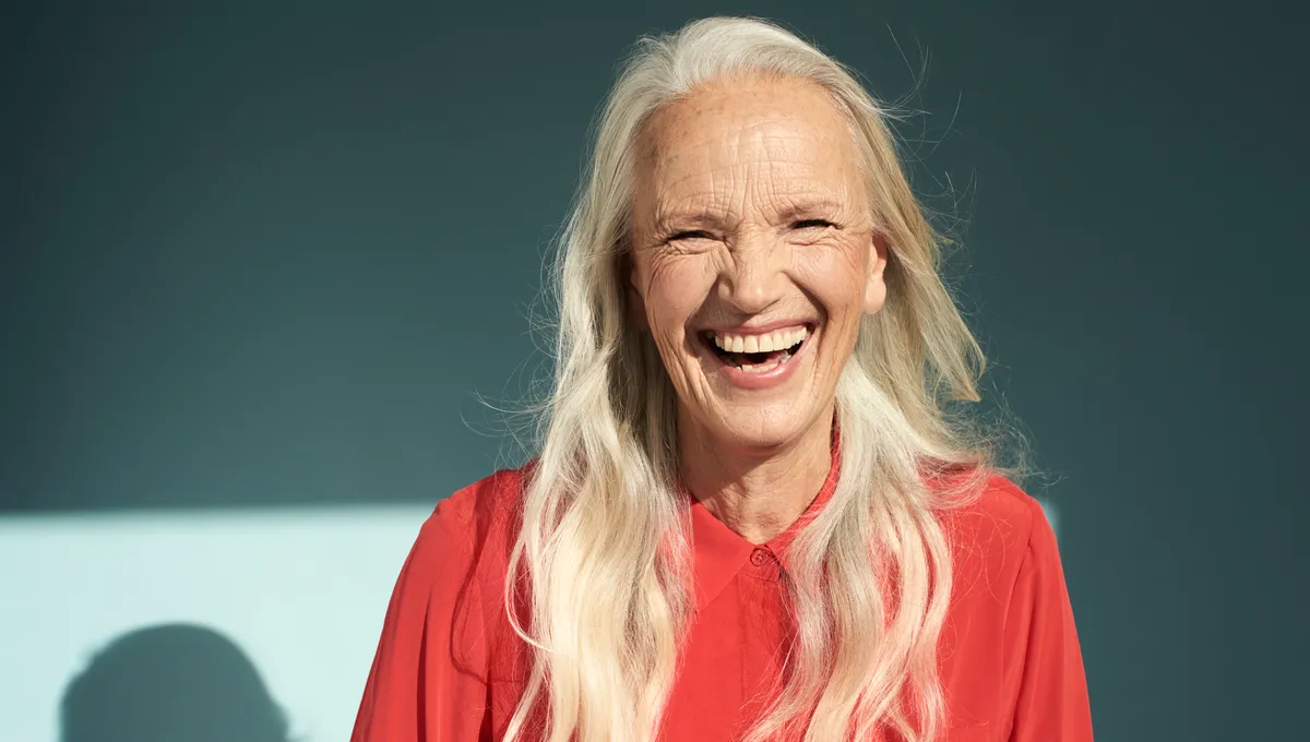 Going Gray: Long Silver Waves and a Great Laugh — woman over 70 comparing going gray versus keeping hair color