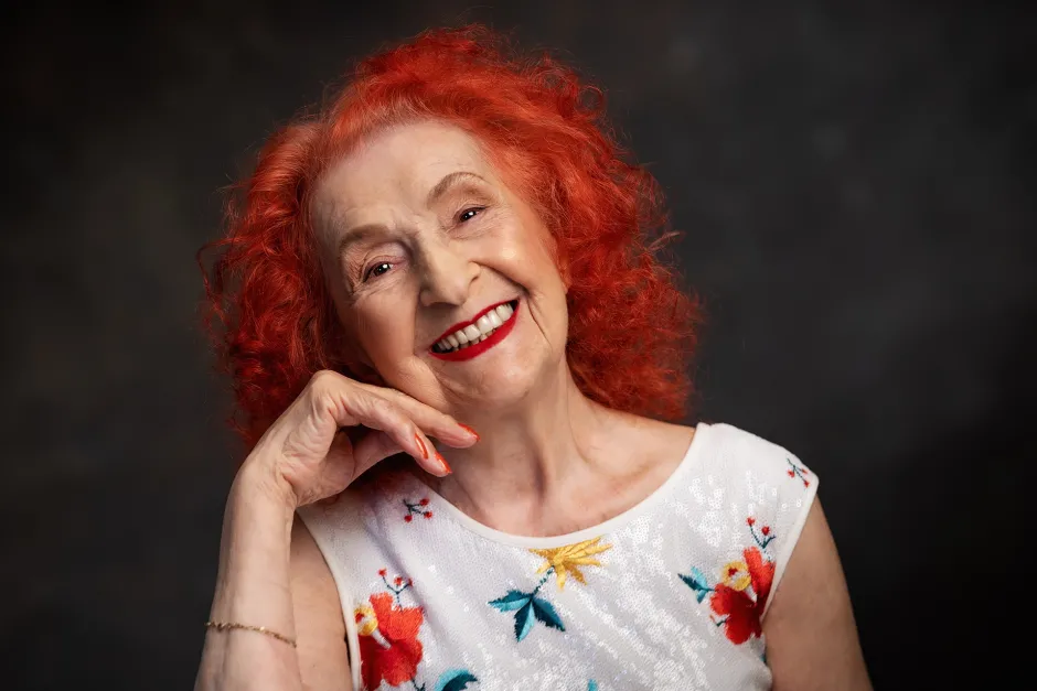 Keeping Colour: Joyful Red Curls With Real Bounce — woman over 70 comparing going gray versus keeping hair color