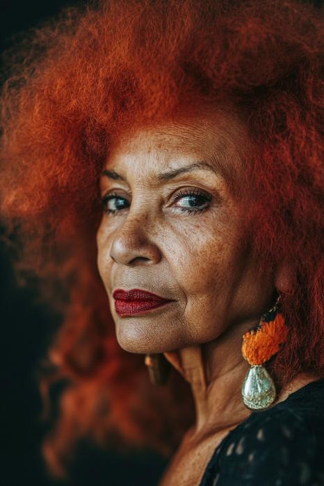 Keeping Colour: A Fiery Red Afro Full of Personality — woman over 70 comparing going gray versus keeping hair color