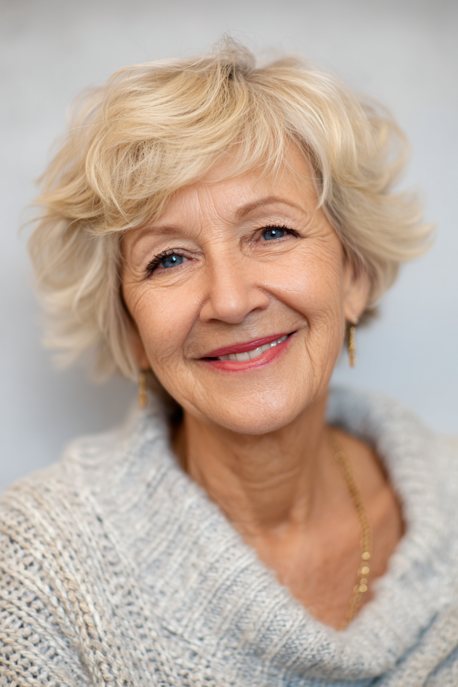 Pearl Blonde Curls That Brighten the Eyes — flattering hair color on a woman over 70 that brightens mature skin
