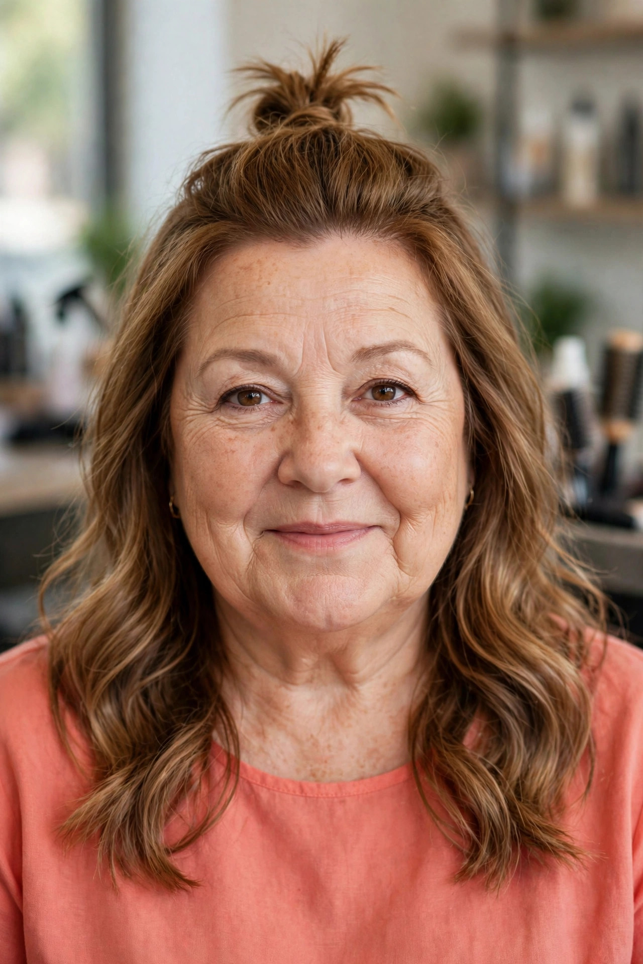 Half-Up Top Knot with Soft Waves on a woman over 50 with a round face - slimming hairstyle