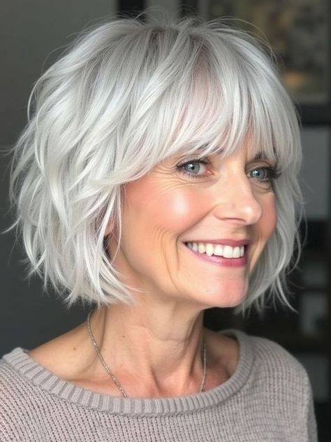 Woman over 70 with a wavy silver bob with a soft fringe — hairstyle that helps a woman over 70 look fresh and younger