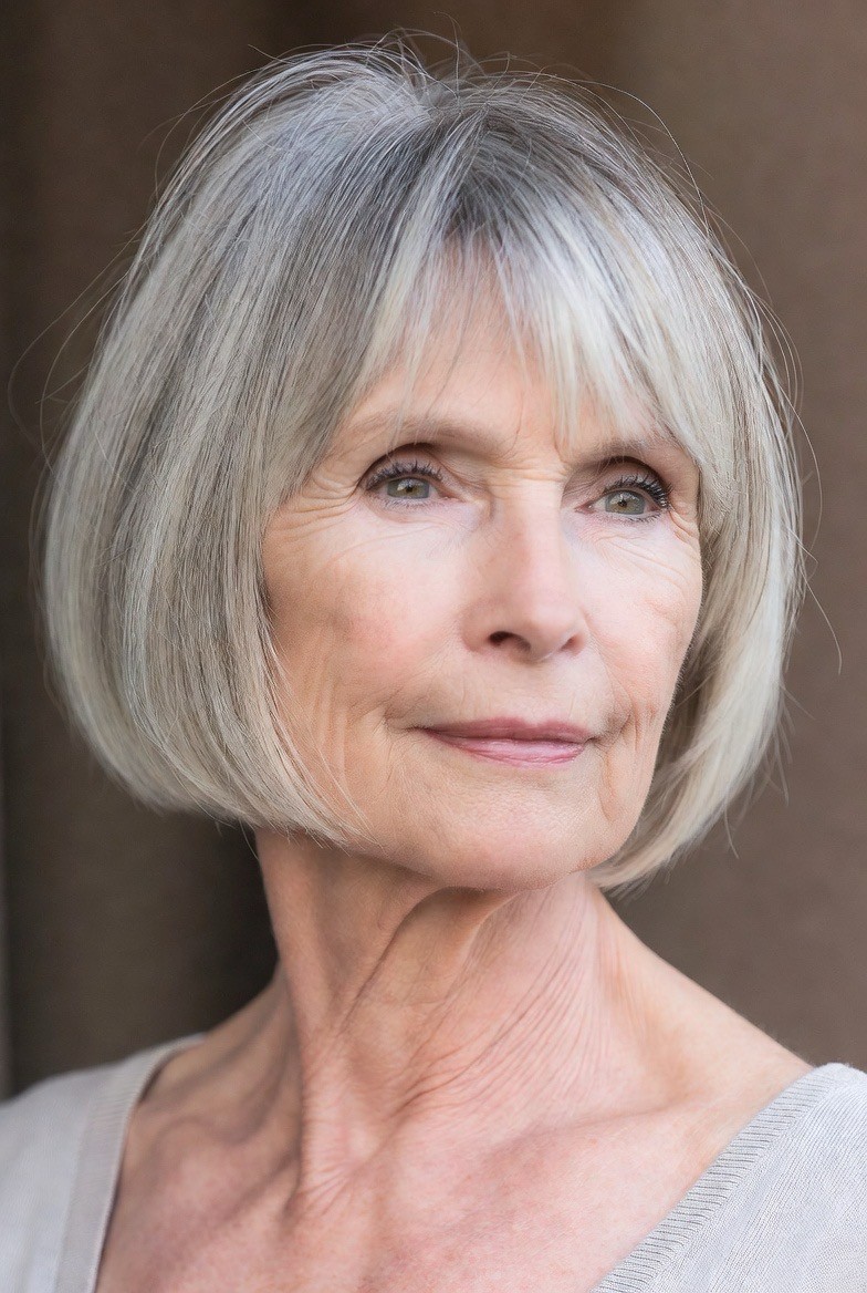 Woman over 70 with soft bob with a feathered, see-through fringe — flattering bangs hairstyle for women over 70
