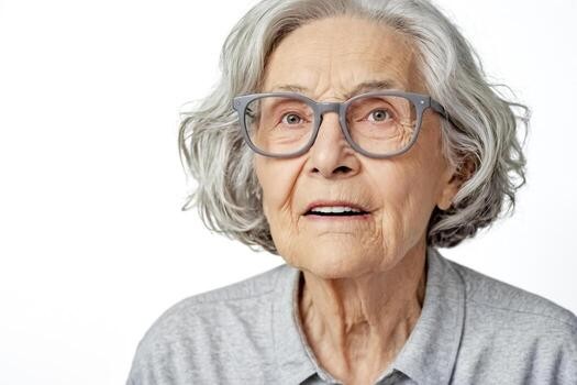 woman over 70 with a gray wavy bob wearing slate-blue glasses