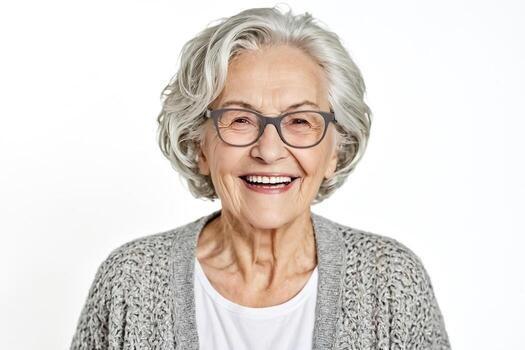laughing woman over 70 with short white curly hair wearing dark glasses