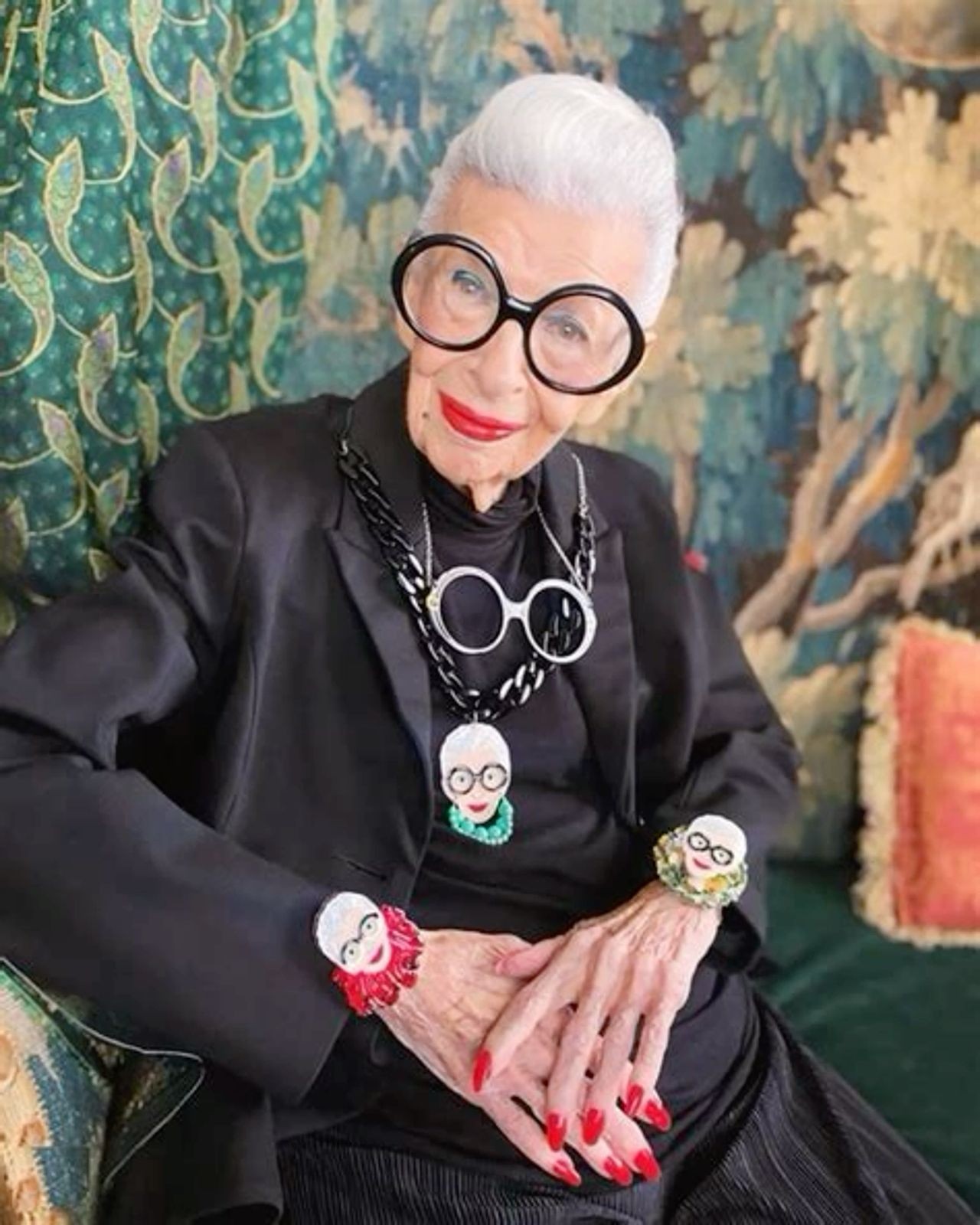 fashionable woman over 70 with a chic white crop wearing oversized round glasses