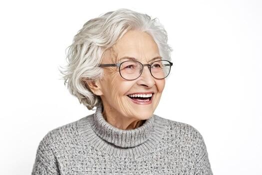laughing woman over 70 with a wavy white bob hairstyle wearing glasses