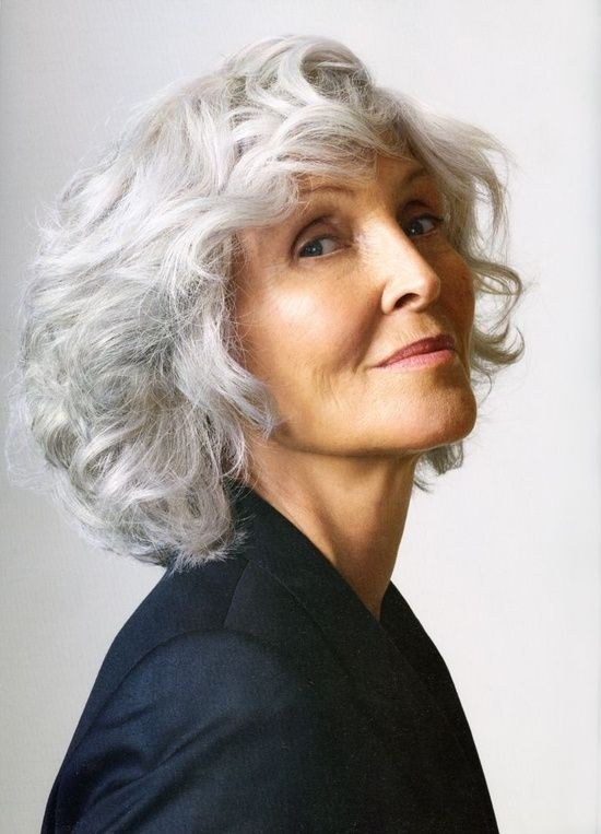 Bright White Wavy Bob With Volume — layered bob on thick wavy hair on a woman over 70