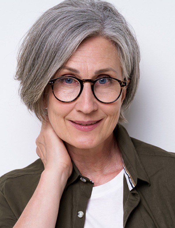 The Layered Pixie-Bob Styled for Glasses — layered haircut that slims a round face on a woman over 70