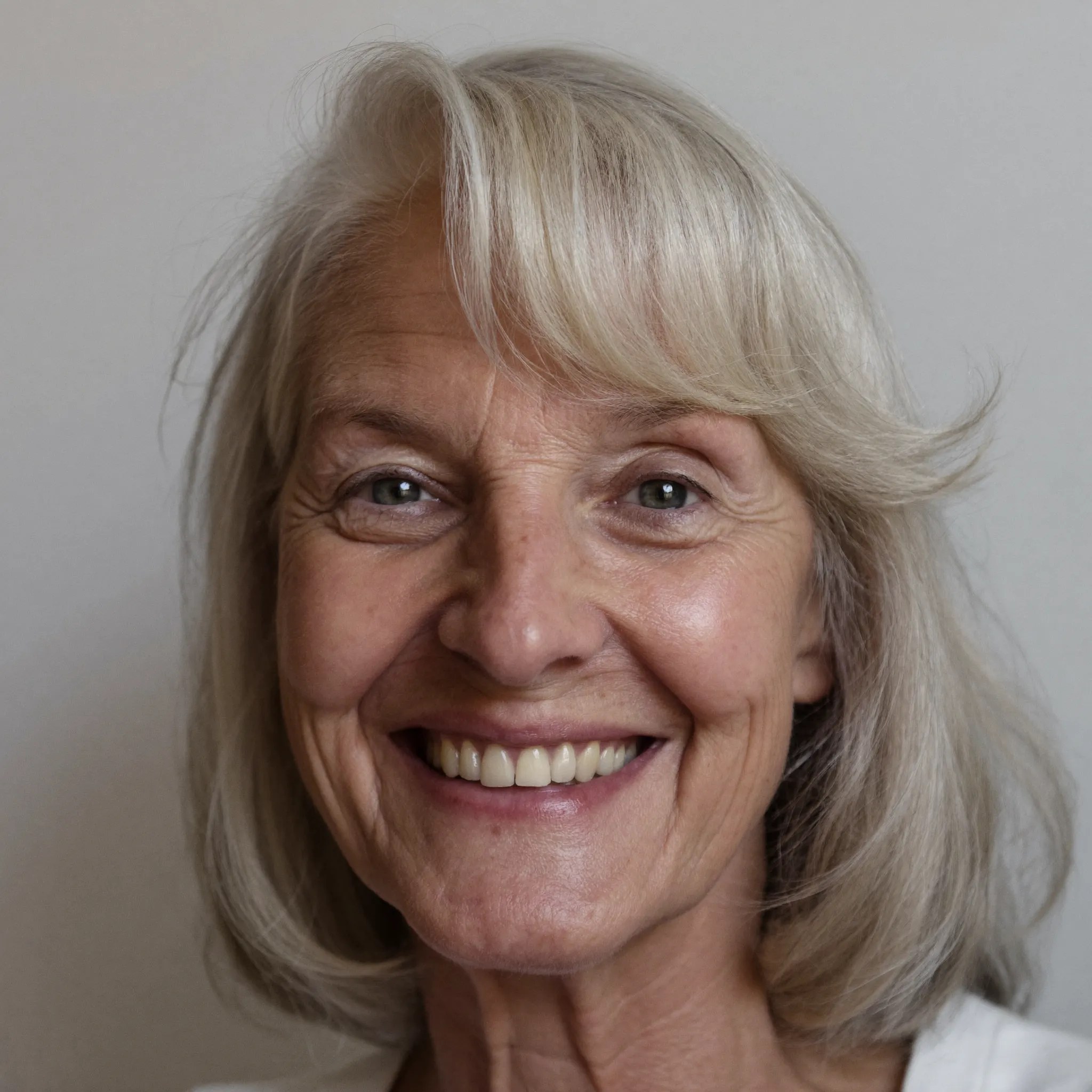 The Blonde Shoulder Cut With a Side Sweep — width-adding haircut for a long narrow face on a woman over 70