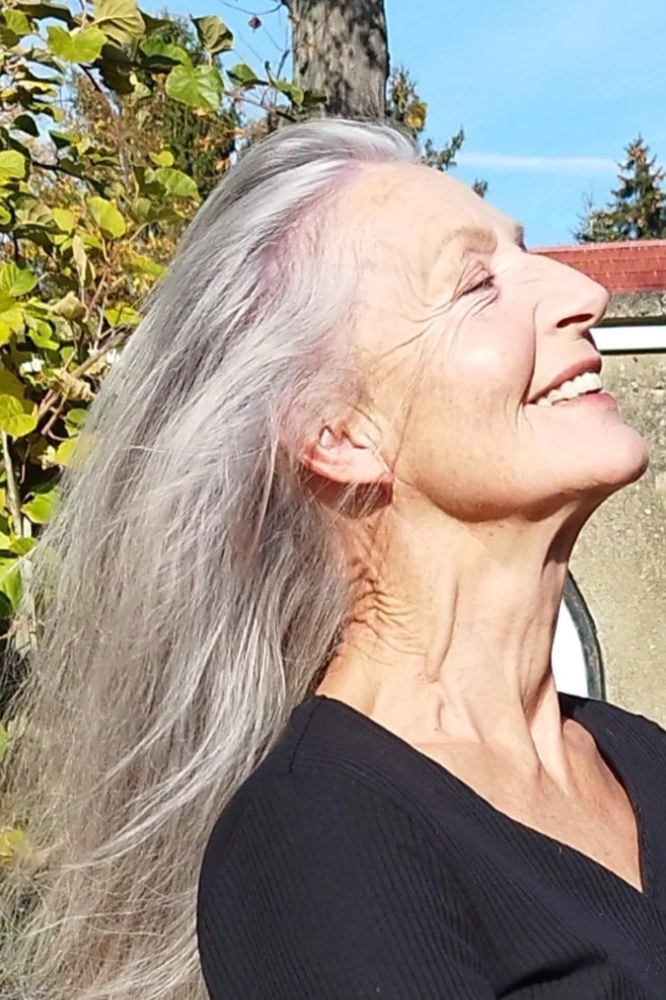 Woman over 70 with silver Length Worn Loose and Windswept — long gray hairstyle inspiration for women over 70