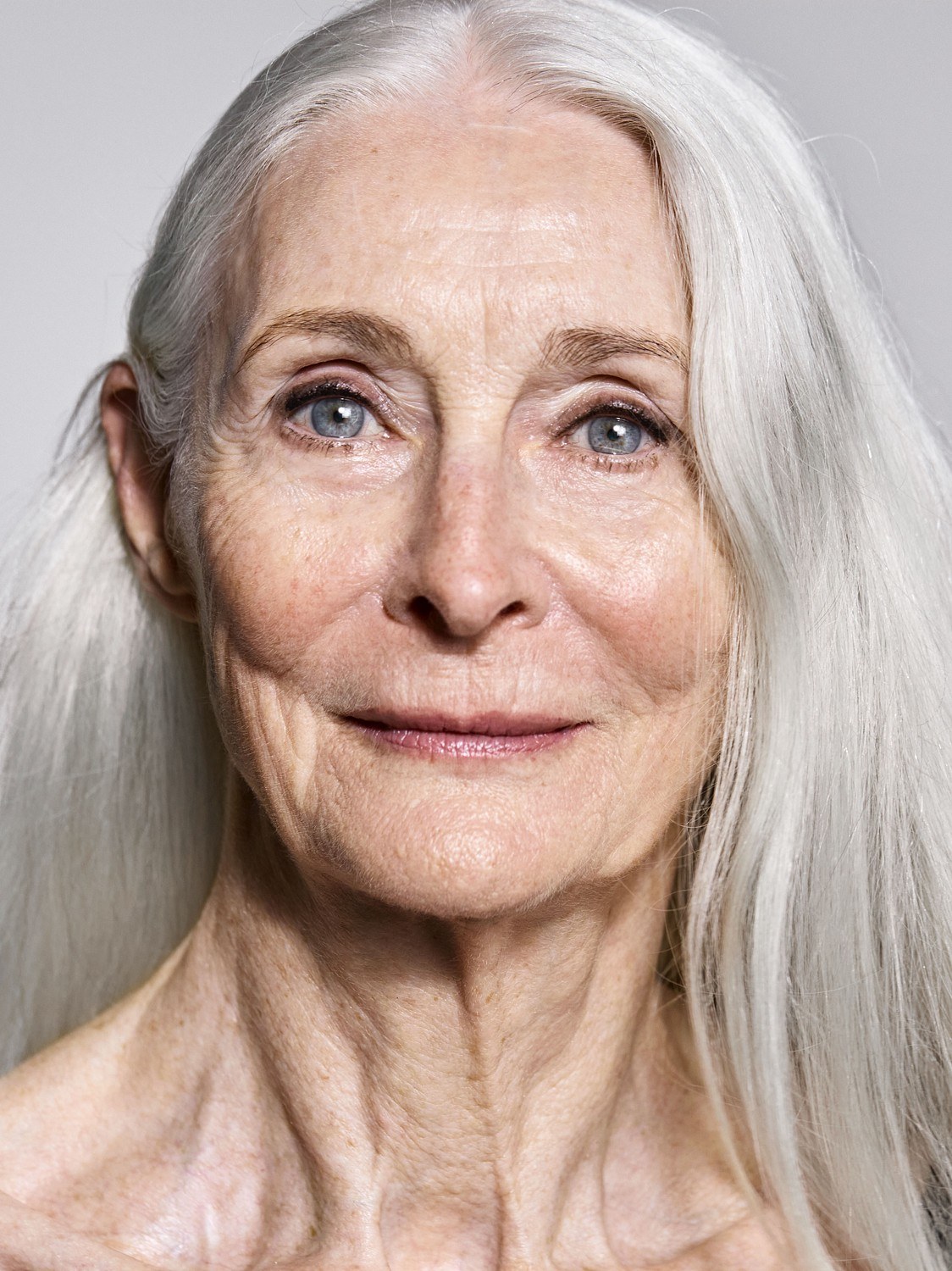 Woman over 70 with long Silver Hair in a Classic Center Part — long gray hairstyle inspiration for women over 70