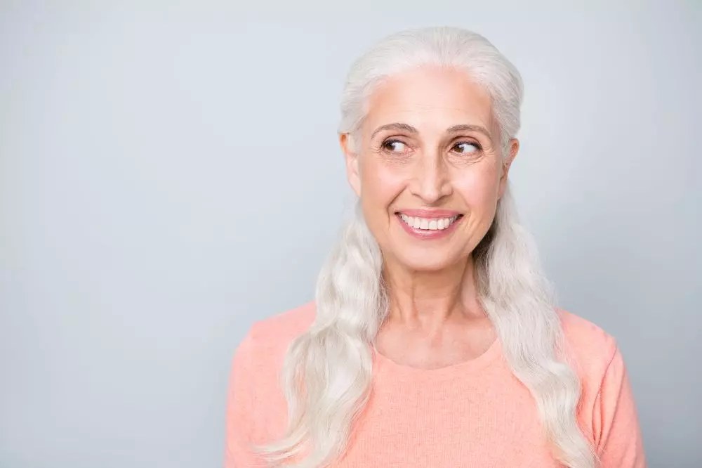 Woman over 70 with long Gray Hair in Two Soft Braids — long gray hairstyle inspiration for women over 70