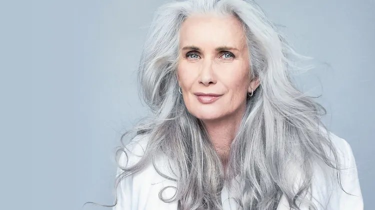 Woman over 70 with silver Length With Feathered Layers Around the Face — long gray hairstyle inspiration for women over 70