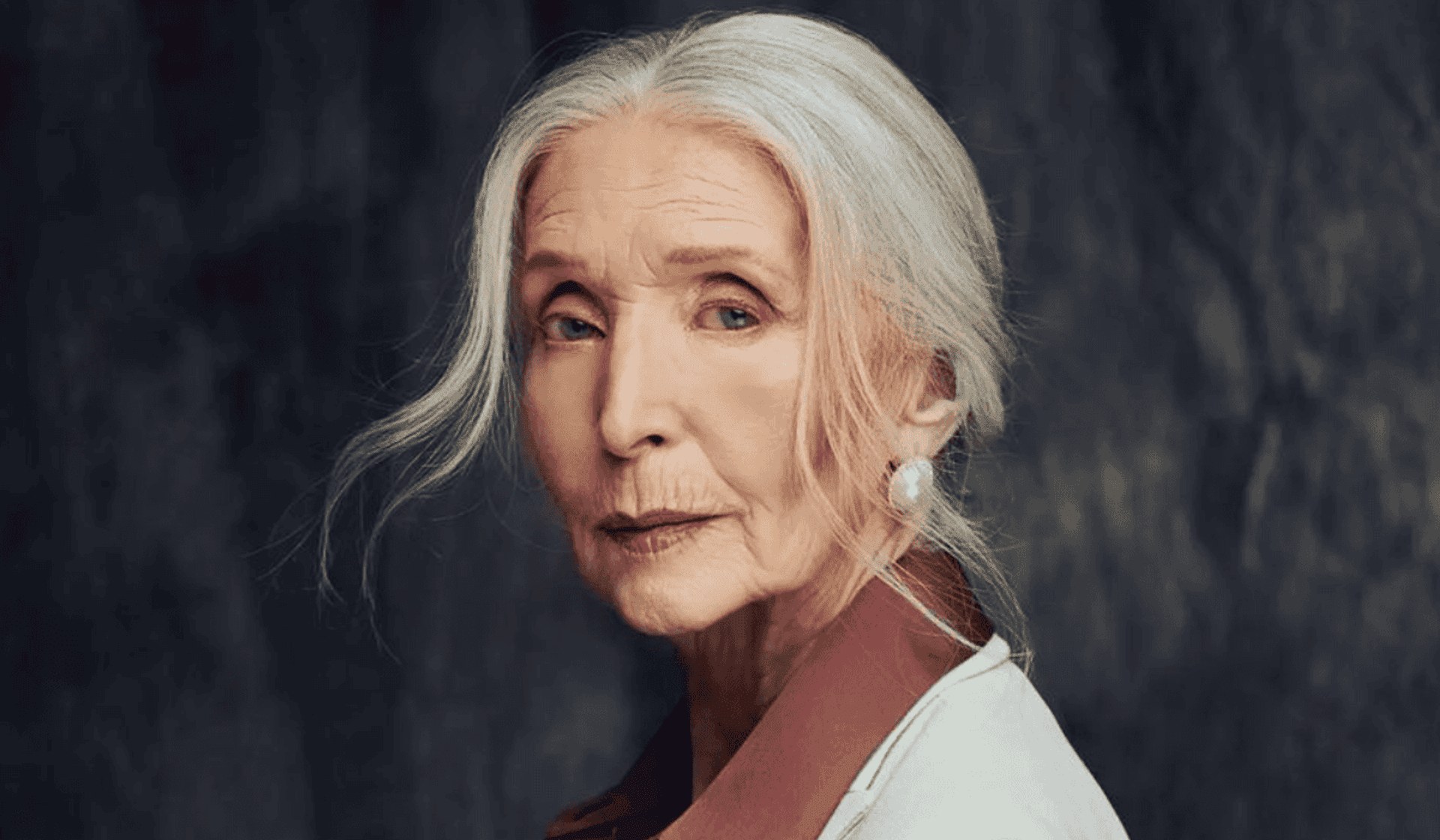 Woman over 70 with white Length in a Low, Loose Ponytail — long gray hairstyle inspiration for women over 70