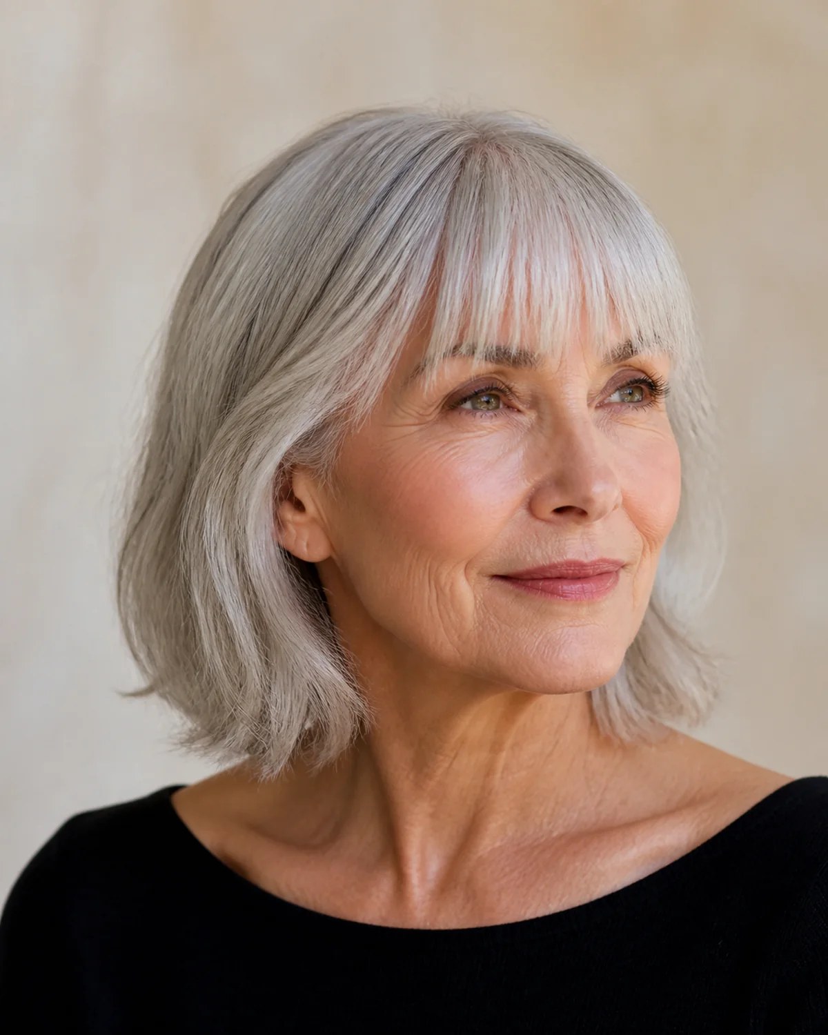 Woman over 70 with silver crop with natural lift at the roots — easy-care hairstyle for women over 70