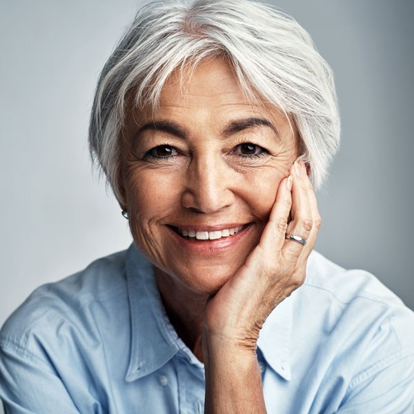 Woman over 70 with low-key pixie with soft, wispy ends — easy-care hairstyle for women over 70