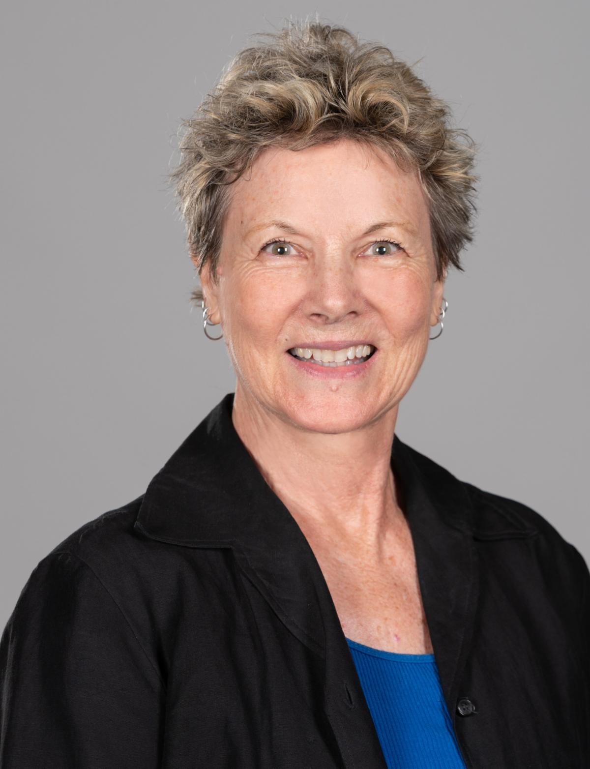 Warm Gray-Brown Dimension in a Short Crop — lowlights for gray hair on a woman over 70 adding depth while hair stays mostly silver