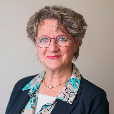 Smoky Lowlights in a Glasses-Friendly Crop — lowlights for gray hair on a woman over 70 adding depth while hair stays mostly silver