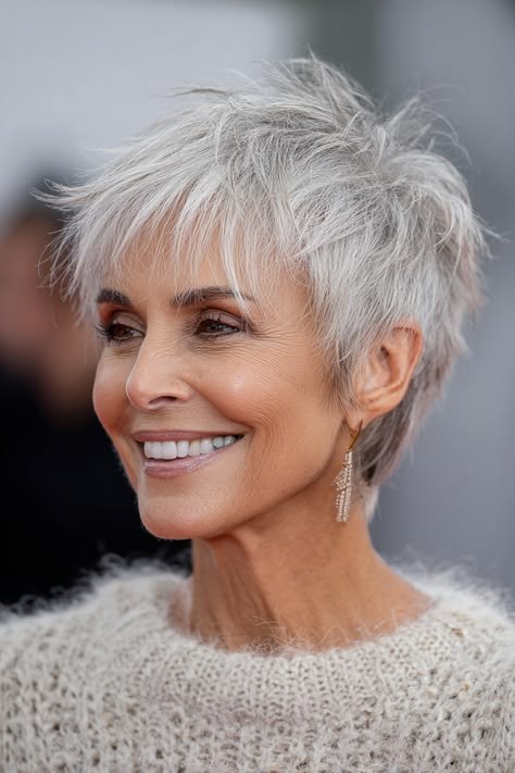 Woman over 70 with a choppy white pixie with soft spikes — modern haircut for women over 70