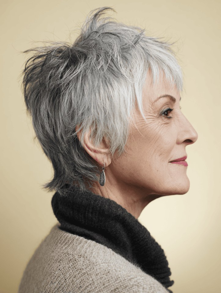 Woman over 70 with a long-nape pixie in profile — modern haircut for women over 70