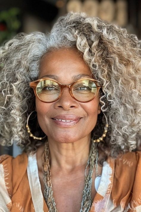 Long Salt-and-Pepper Curls With Glasses — curly hairstyle on a woman over 70 with natural texture
