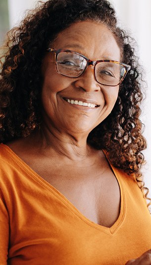 Rich Dark Curls With Silver Threads — curly hairstyle on a woman over 70 with natural texture
