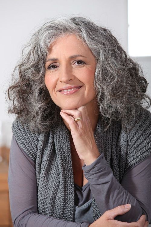 Long Layered Gray Curls — curly hairstyle on a woman over 70 with natural texture