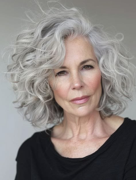 Soft Shoulder-Length Curls in Bright Silver — curly hairstyle on a woman over 70 with natural texture