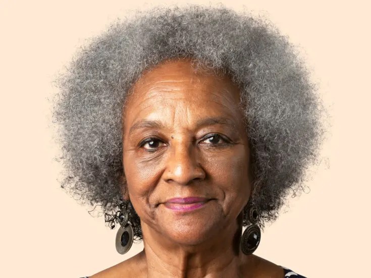 The Silver Afro With Soft Fringe Curls — natural hairstyle on a Black woman over 70