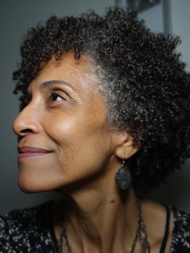 Short Natural Curls in Profile — natural hairstyle on a Black woman over 70