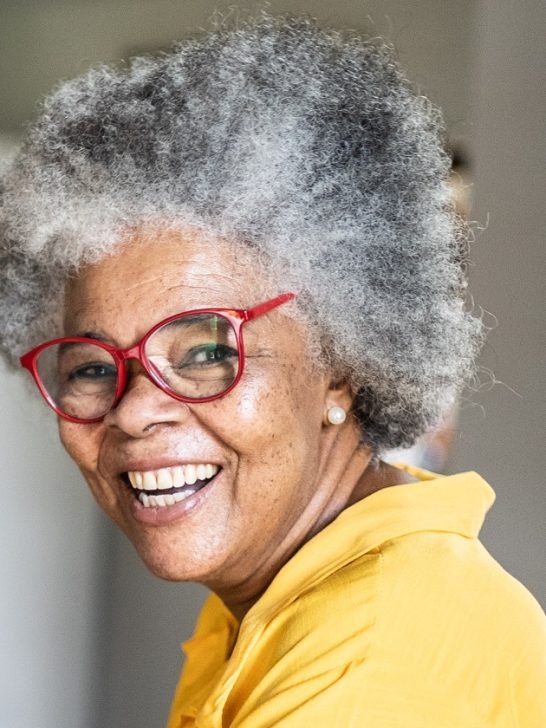 The Gray Afro With Statement Glasses — natural hairstyle on a Black woman over 70