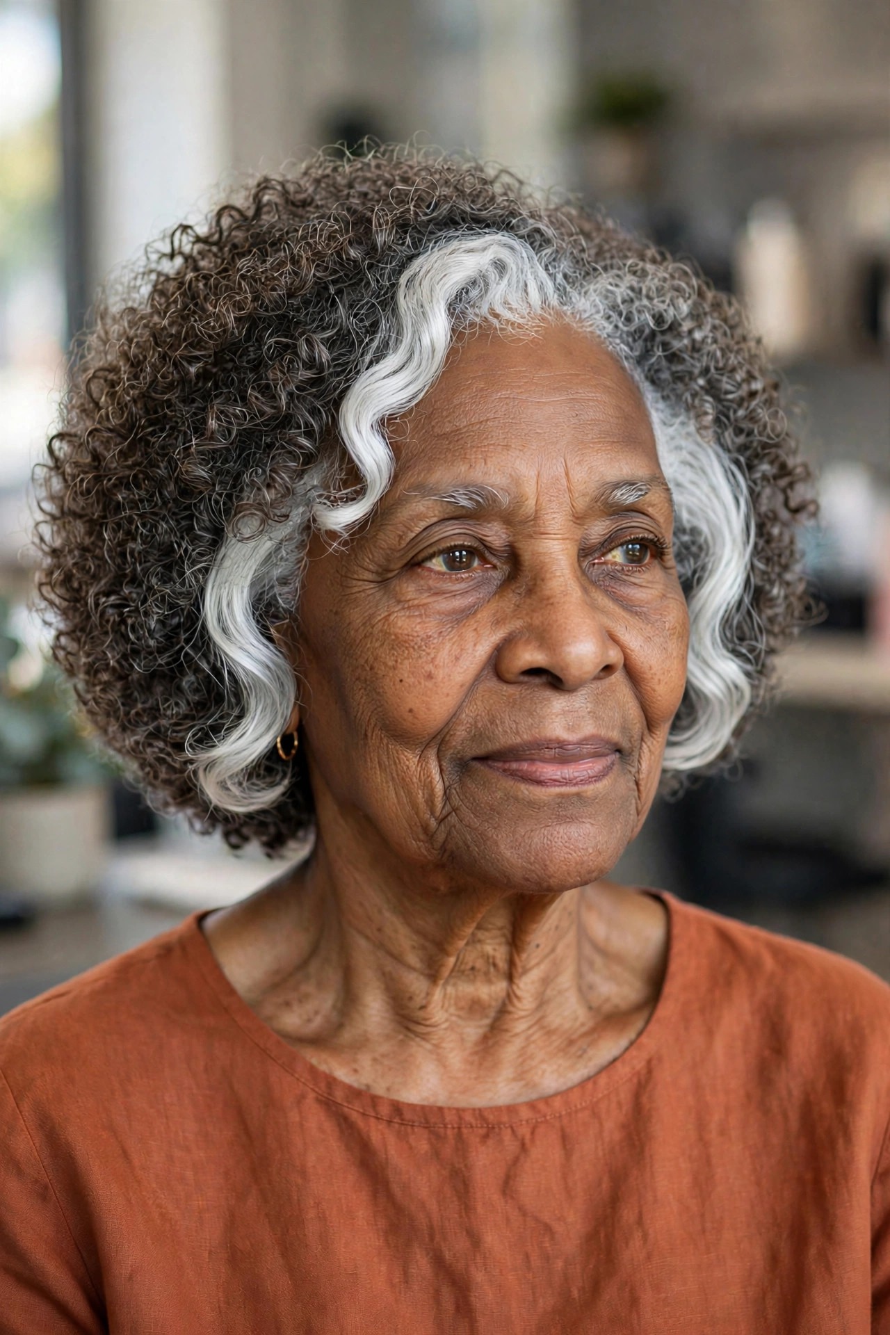 Curly Natural Bob with Silver Face Frame - natural hairstyle on a Black woman over 60 with gray hair