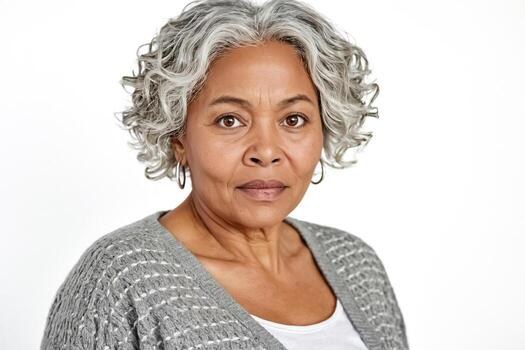 The Gray Curly Bob With Rounded Volume — round face hairstyle on a woman over 70