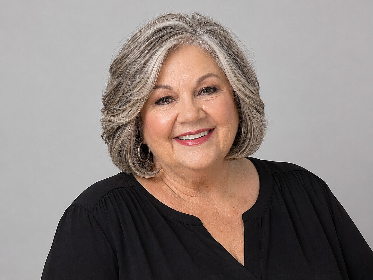 The Feathered Bob That Falls Below the Chin — round face hairstyle on a woman over 70