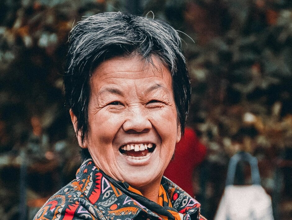 The Short Salt-and-Pepper Crop, Worn With a Big Smile — round face hairstyle on a woman over 70