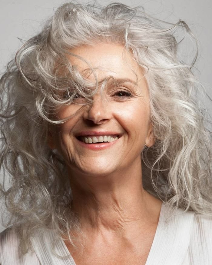 Wild Silver Curls With Lifted Roots — round face hairstyle on a woman over 70