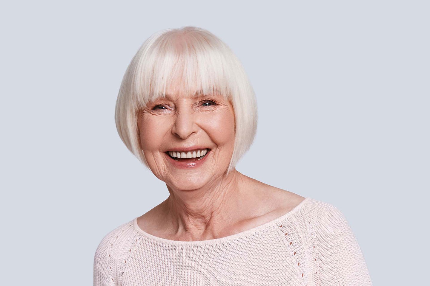 The Snow-White Bob With a Blunt Fringe — round face hairstyle on a woman over 70