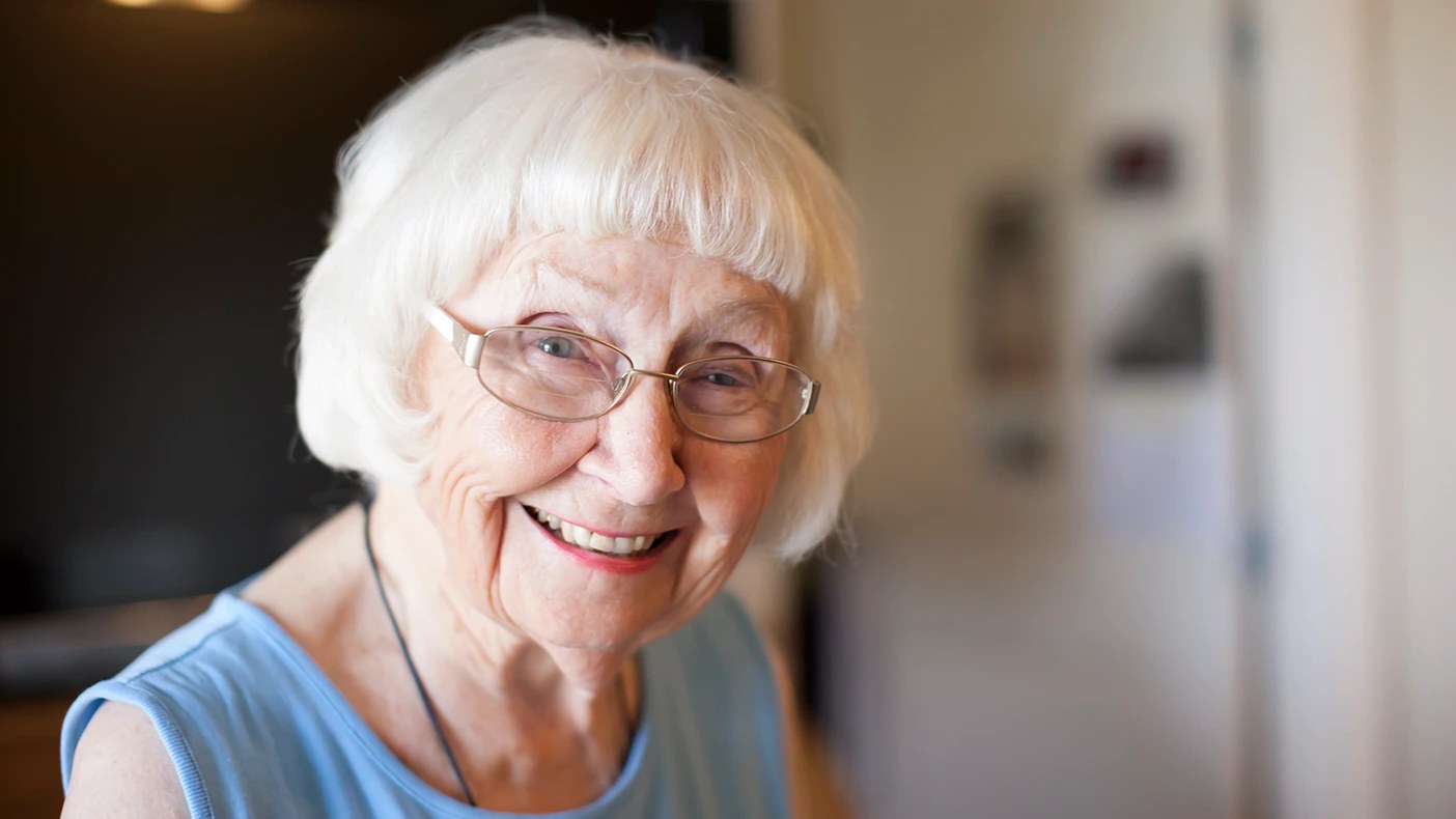 The Pageboy-Style White Bob With Soft Glasses Styling — round face hairstyle on a woman over 70