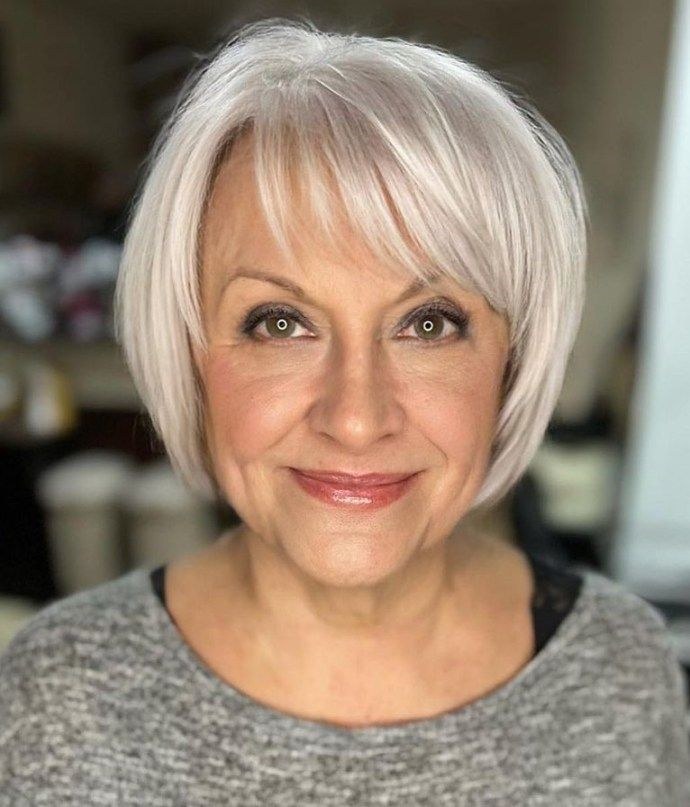 The White Bob With a Soft, Face-Framing Fringe — round face hairstyle on a woman over 70